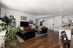 Living area with wood finished floors and recessed lighting