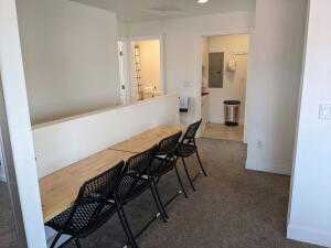 Hallway and convertible dining area, with drop down wall tables and folding chairs