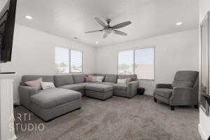 Living room with ceiling fan, carpet, and recessed lighting