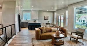 Living area featuring light wood-style flooring, recessed lighting, and french doors