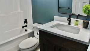 Bathroom with vanity and washtub / shower combination