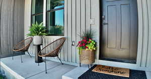 Property entrance featuring board and batten siding