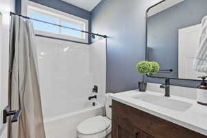 Full bathroom with shower / bath combo and vanity