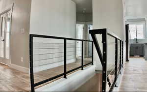 Stairway with wood finished floors and recessed lighting