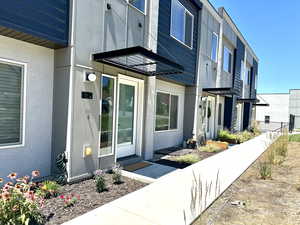 Doorway to property with stucco siding