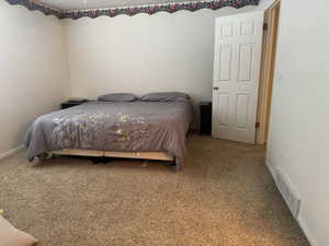 Carpeted bedroom with baseboards