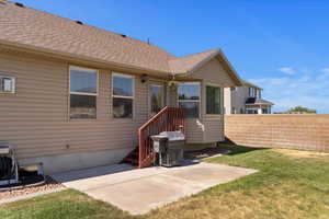 Back of property featuring a patio and roof with shingles