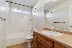 Full bath featuring shower / bathtub combination, vanity, and tile patterned flooring