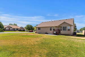 Rear view of house with a lawn