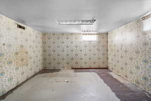 Basement with wallpapered walls