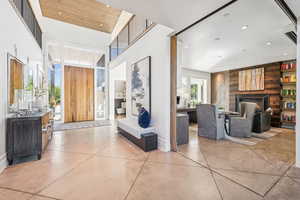 Hallway with finished concrete floors, recessed lighting, and a towering ceiling