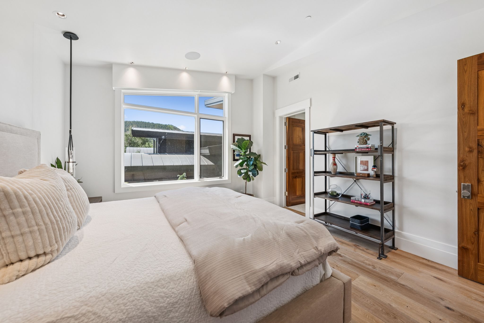 Bedroom featuring light wood-style floors and baseboards