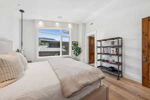 Bedroom featuring light wood-style floors and baseboards