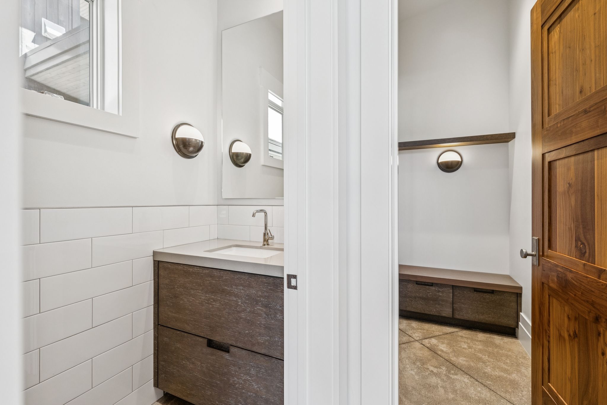 Bathroom featuring vanity, tile walls, and concrete floors