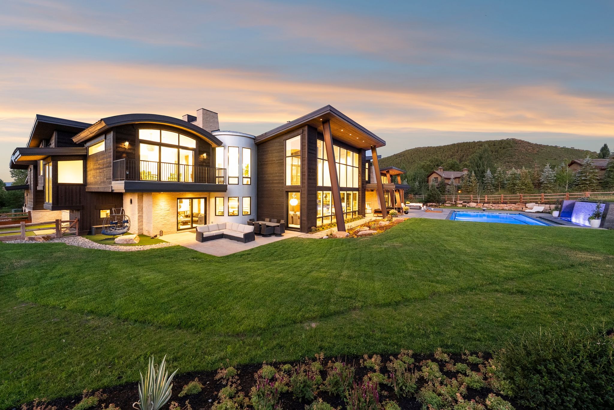 Rear view of property with a balcony, an outdoor hangout area, and a patio area