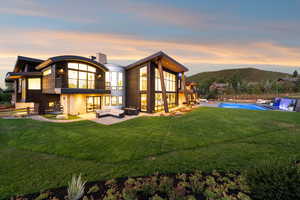 Rear view of property with a balcony, an outdoor hangout area, and a patio area