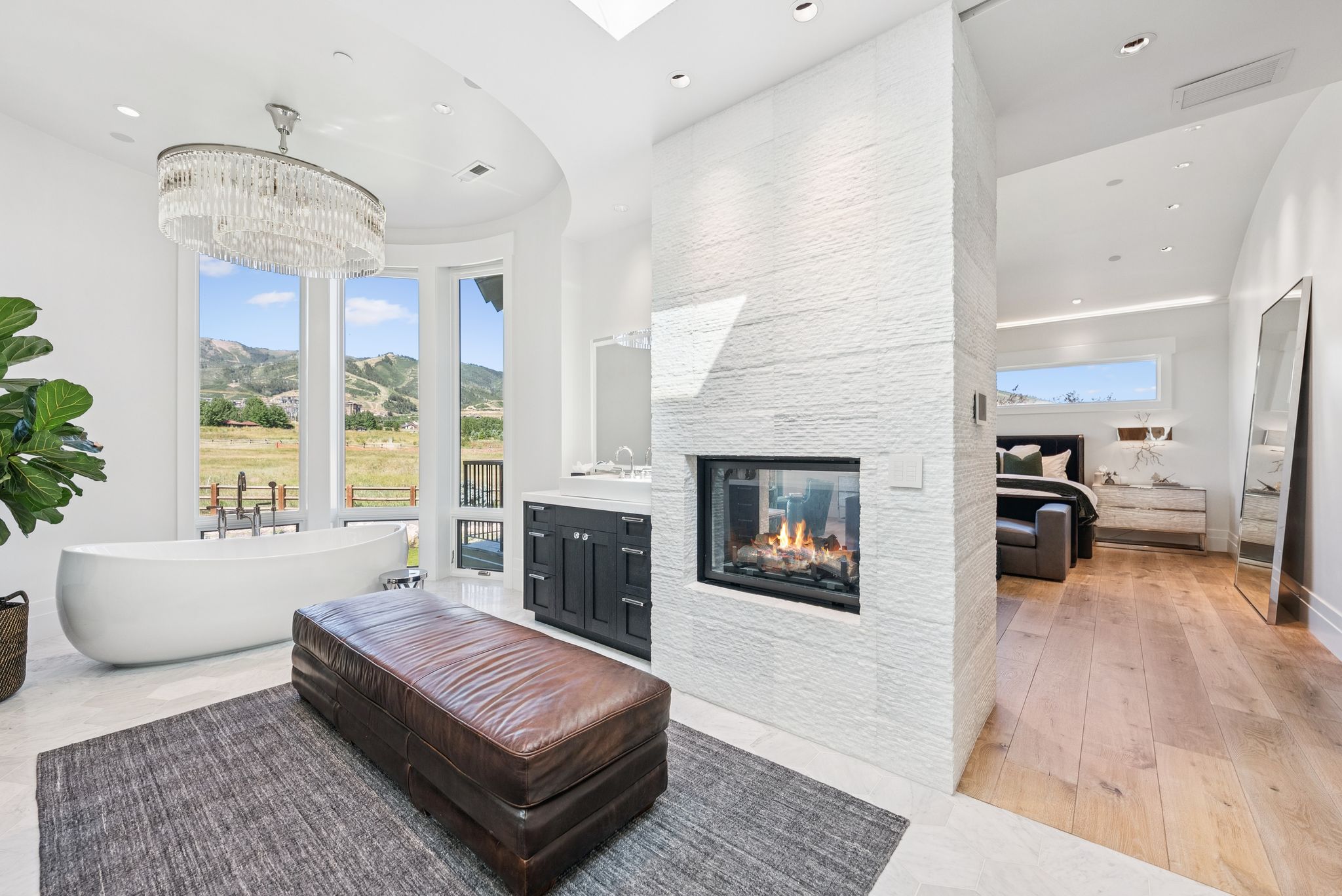 Living room featuring recessed lighting, a fireplace, light wood-style floors, and a chandelier