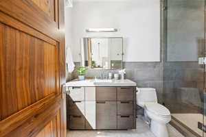 Full bathroom featuring vanity and tiled shower