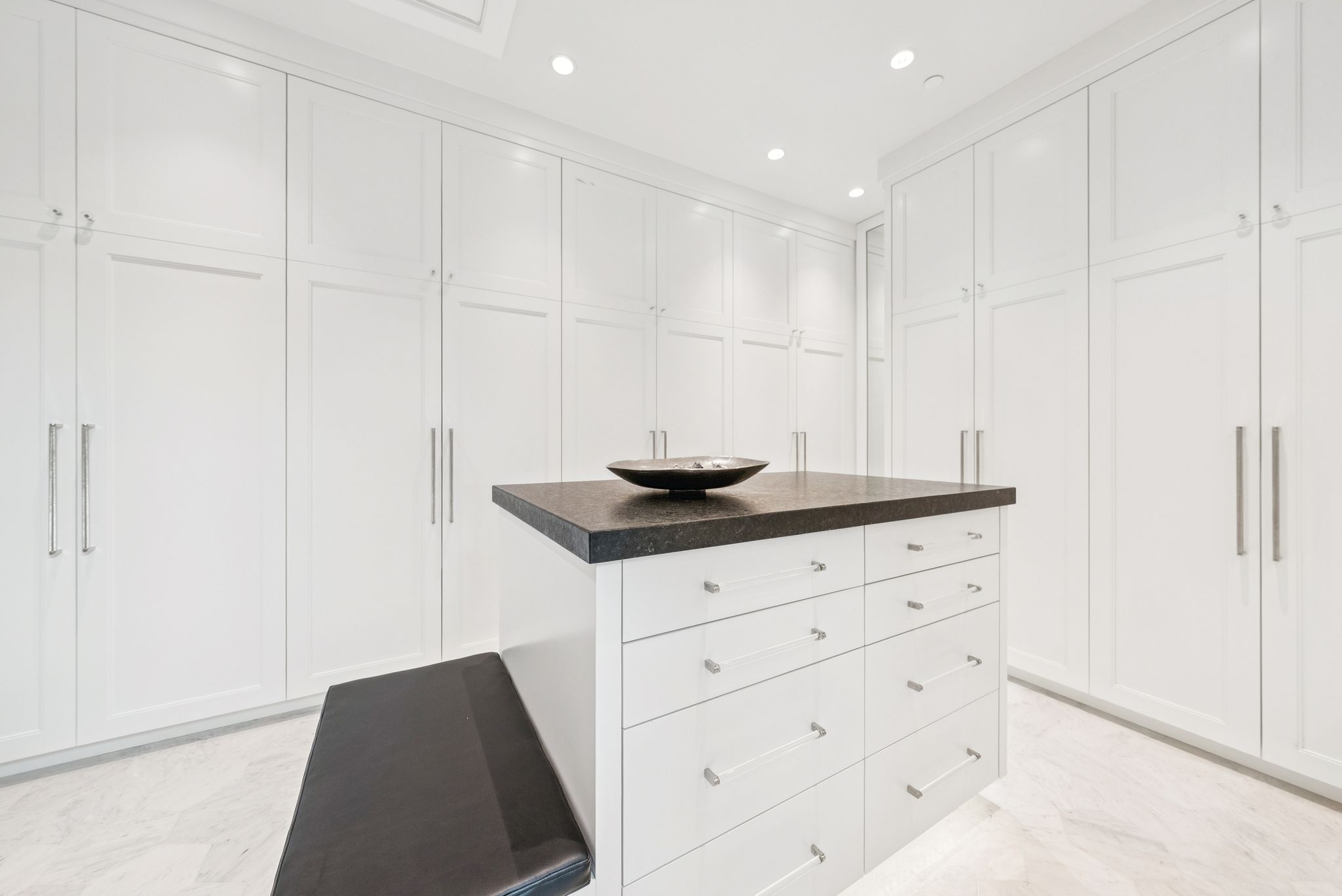 Walk in closet featuring light marble finish floors