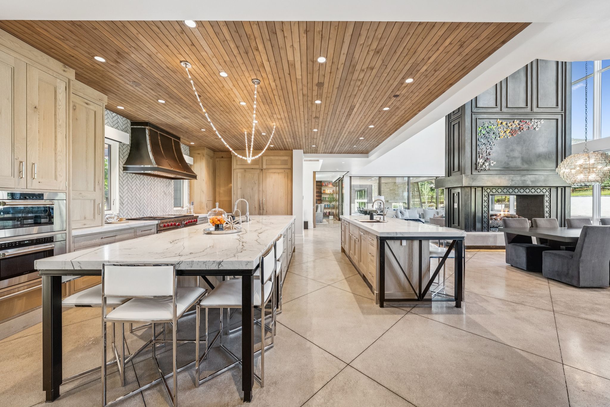 Kitchen with wooden ceiling, a spacious island, recessed lighting, premium range hood, and light stone counters