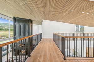 Corridor featuring wooden ceiling, light wood-style floors, and recessed lighting
