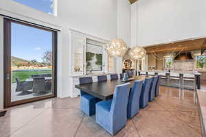 Dining area featuring a chandelier, a high ceiling, and concrete floors