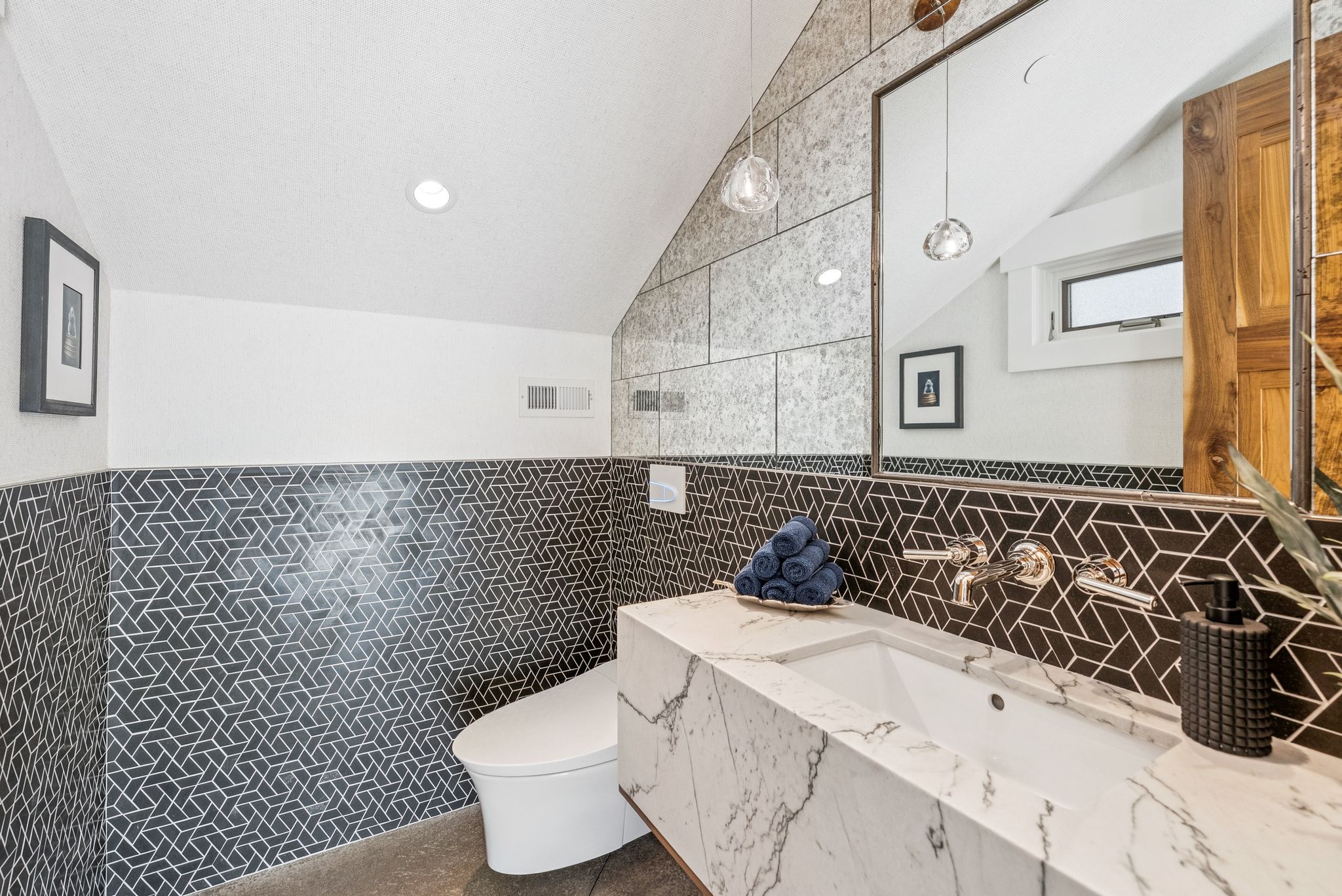 Bathroom featuring lofted ceiling, tile walls, and vanity