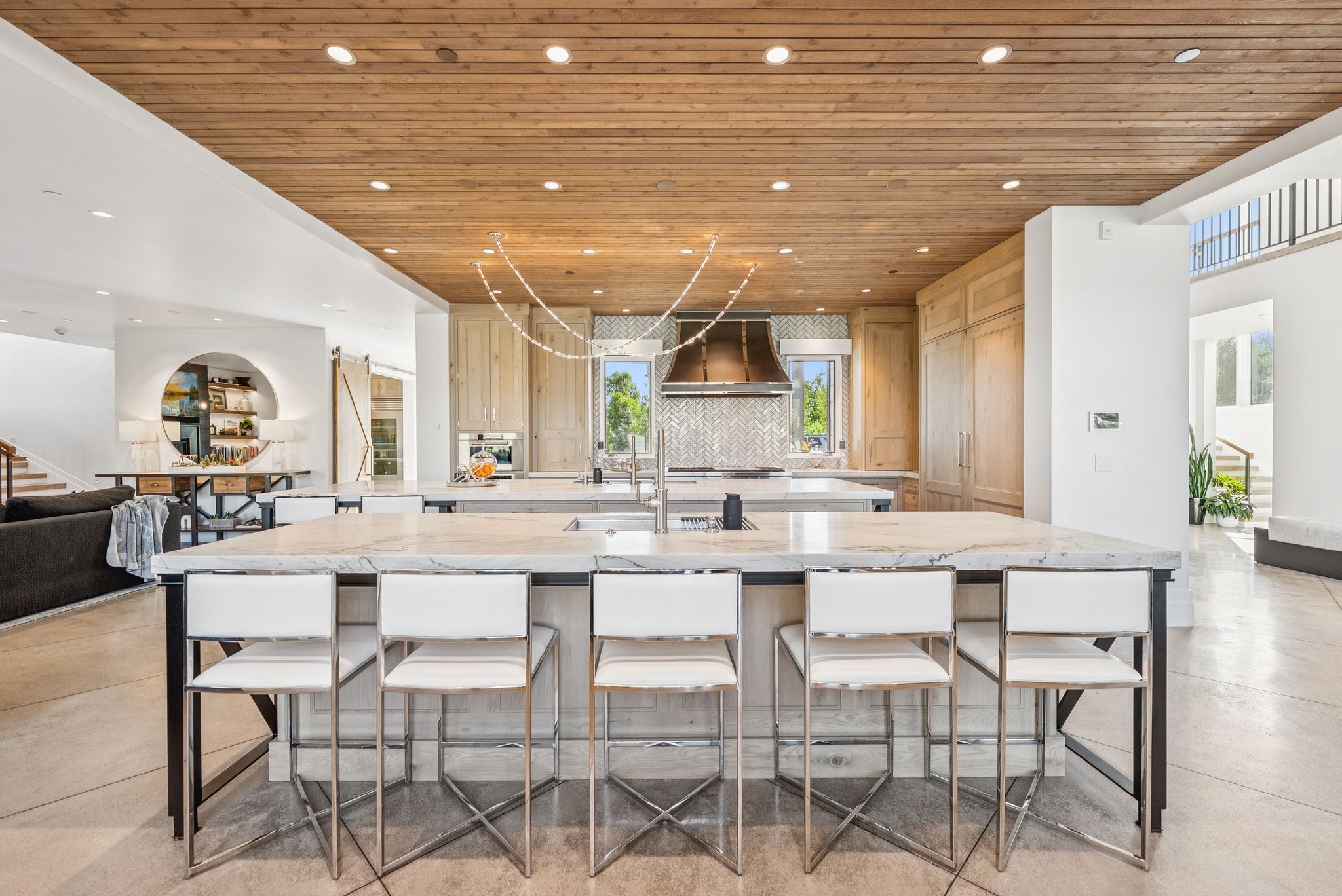 Kitchen with wooden ceiling, custom exhaust hood, a spacious island, recessed lighting, and a breakfast bar area