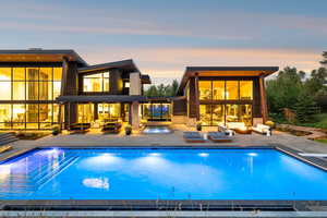 Pool at dusk featuring an outdoor hangout area, an outdoor pool, and a patio