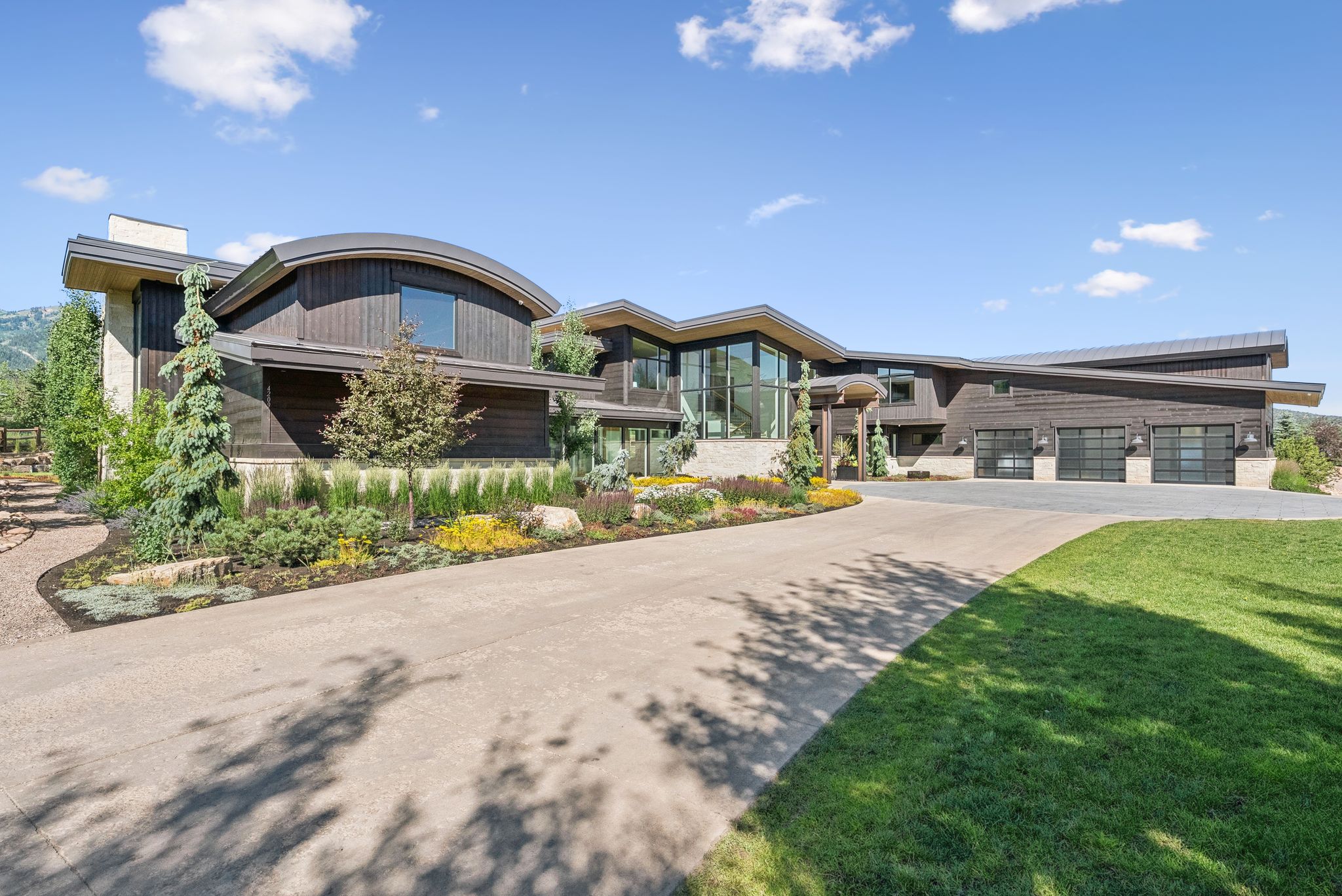 View of property with concrete driveway