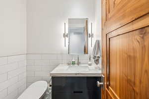 Bathroom with tile walls and vanity