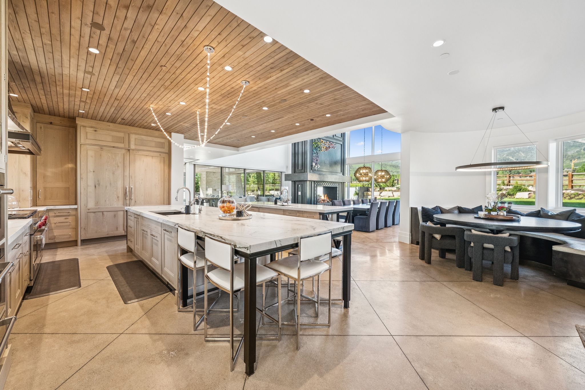 Kitchen with recessed lighting, wood ceiling, a large island, open floor plan, and light stone counters