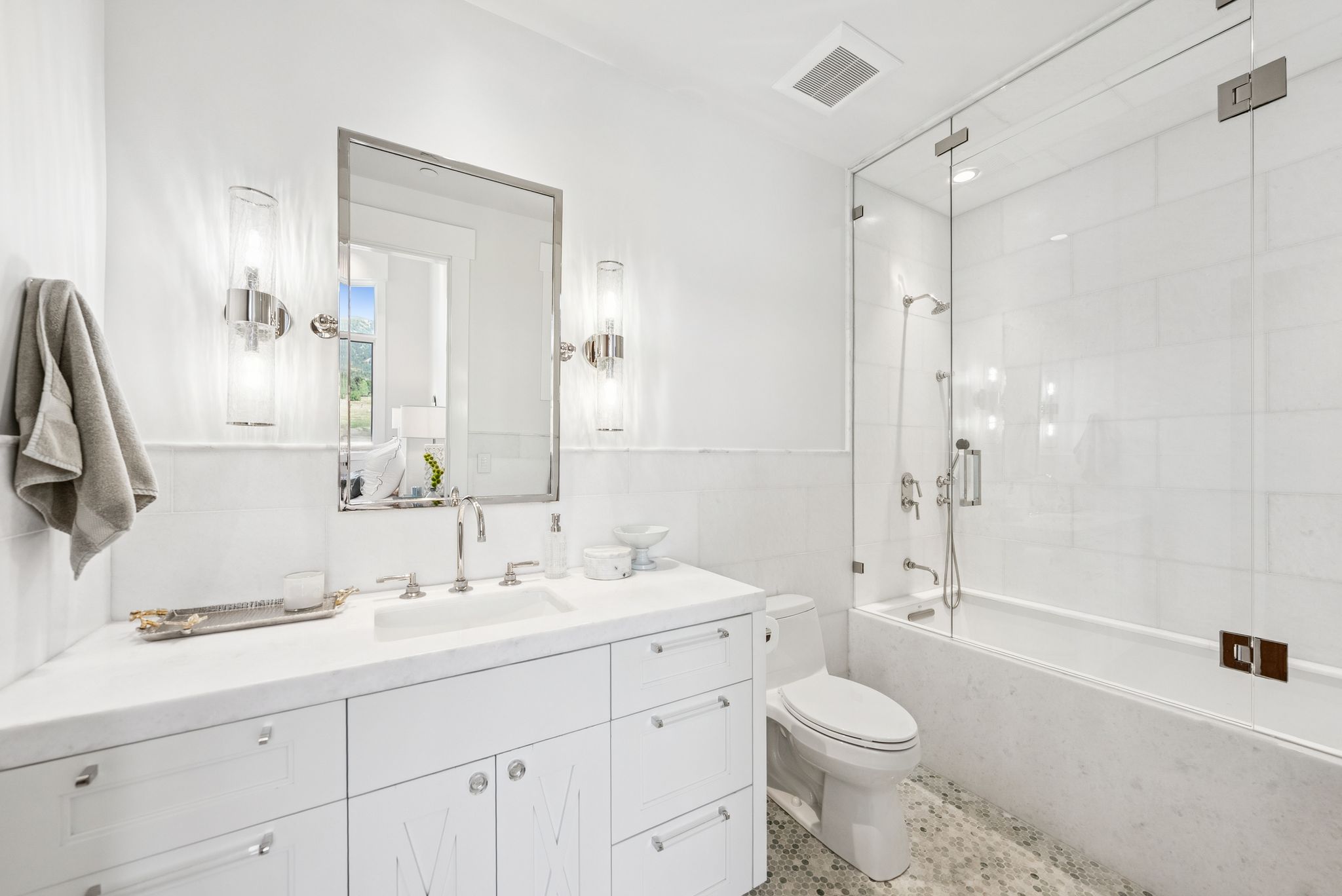 Full bathroom featuring vanity, combined bath / shower with glass door, and speckle patterned floor