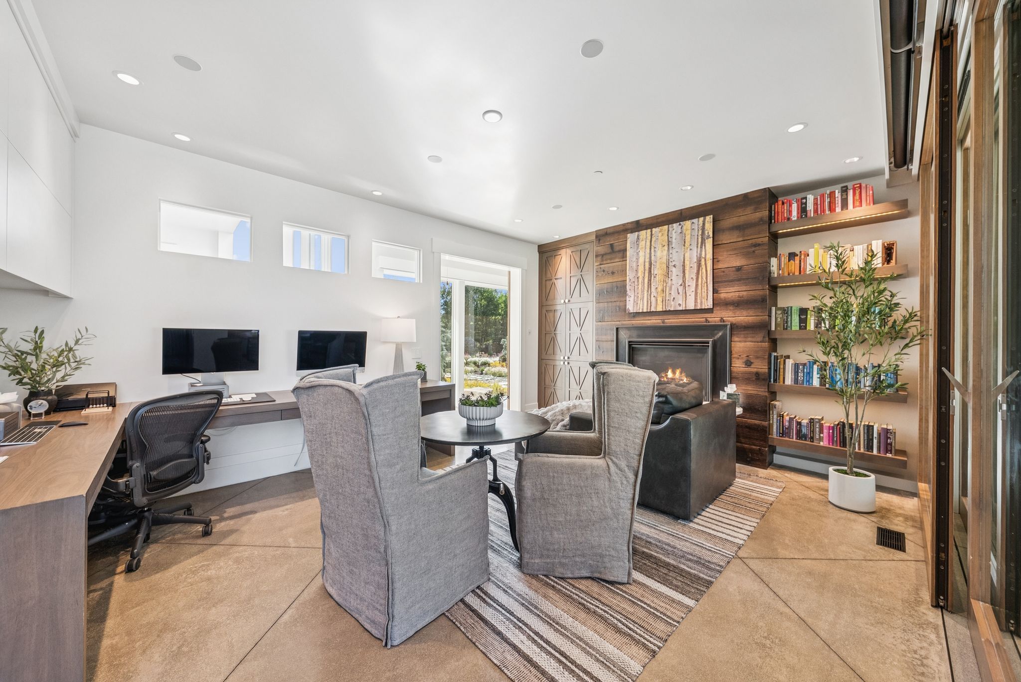 Office featuring a warm lit fireplace and recessed lighting