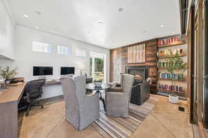 Office featuring a warm lit fireplace and recessed lighting