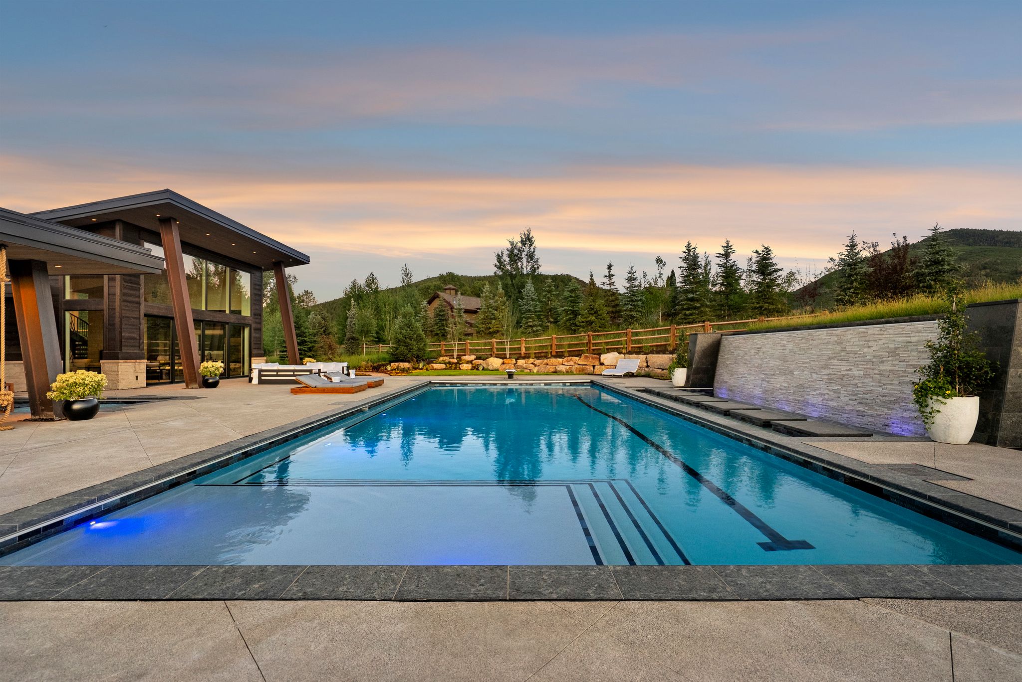 Pool at dusk featuring a patio area and an outdoor pool