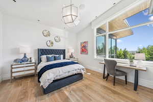 Bedroom with wood-type flooring and lofted ceiling
