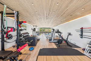 Gym with wood finished floors, wooden ceiling, and recessed lighting