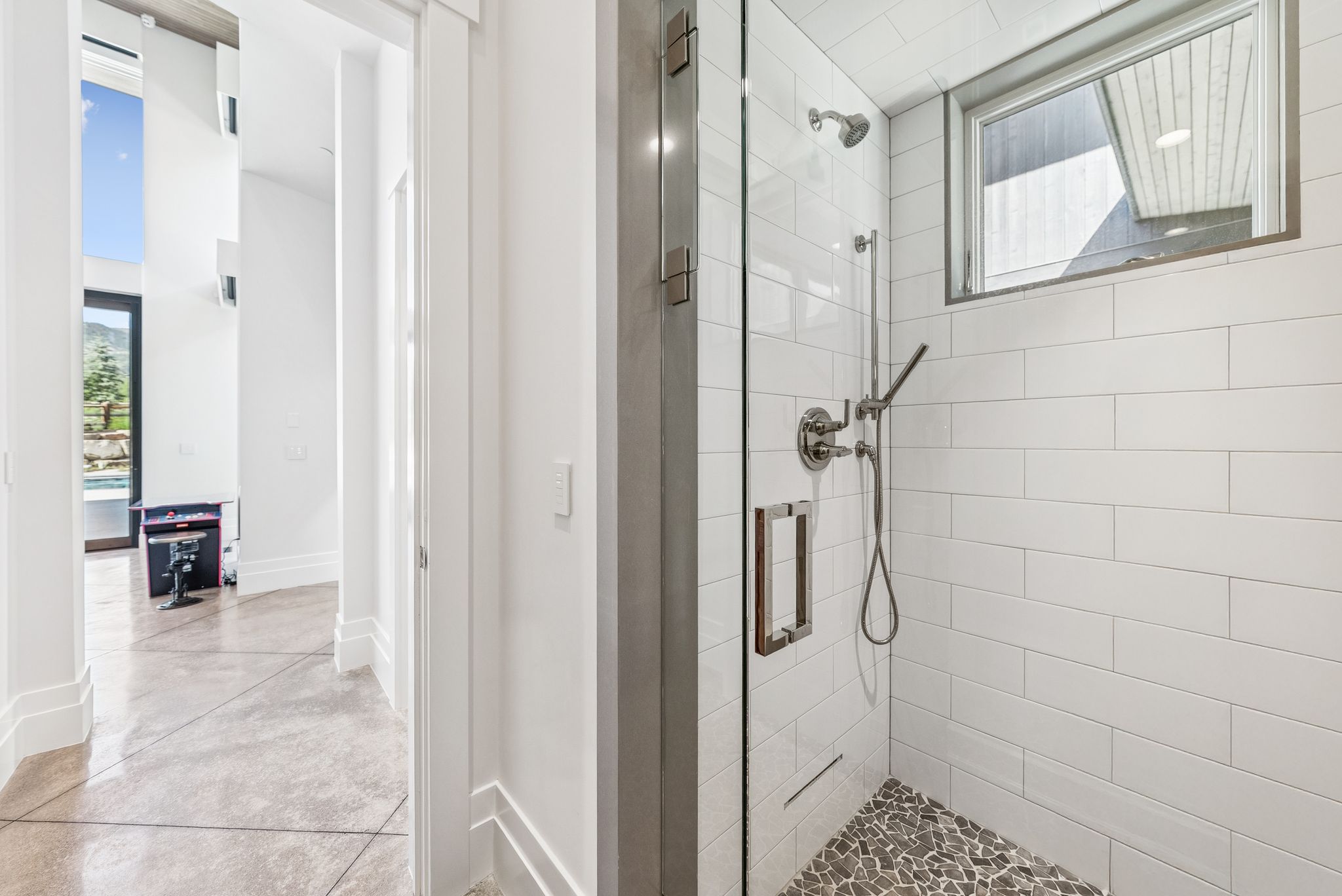 Bathroom featuring a shower stall and finished concrete floors