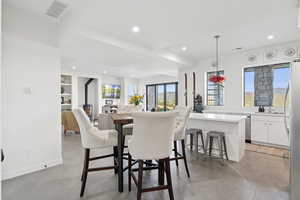 Dining area featuring concrete flooring and recessed lighting