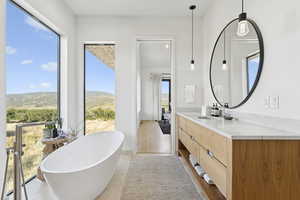 Full bath with vanity and a freestanding bath