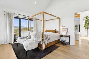 Bedroom with wood finished floors and access to outside