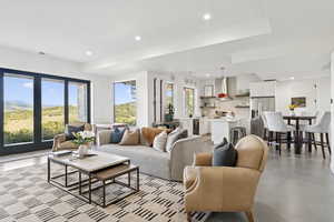 Living room featuring recessed lighting, healthy amount of natural light, and concrete floors