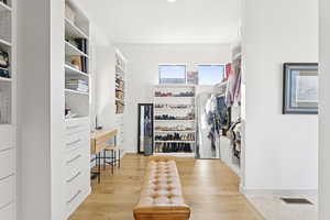 Spacious closet with light wood-style floors