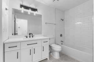 Full bathroom featuring vanity, tile patterned flooring, and bathing tub / shower combination