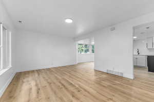 Empty room featuring light wood-type flooring and baseboards