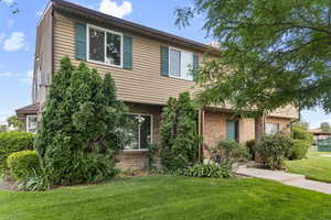 View of front of home featuring brick siding and a front lawn