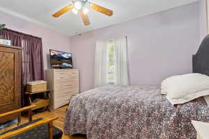 Bedroom featuring light wood finished floors and a ceiling fan