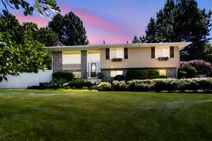 Split foyer home with stucco siding and brick siding