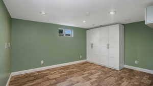 Unfurnished bedroom featuring wood finished floors, a closet, and recessed lighting